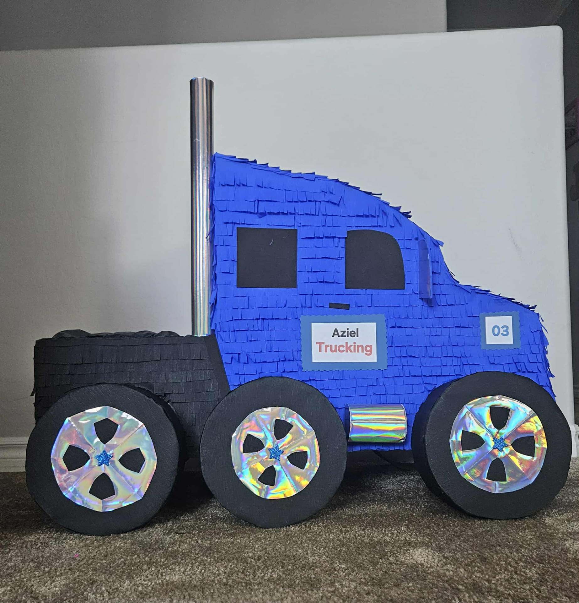 Custom blue semi-truck piñata with Aziel Trucking logo